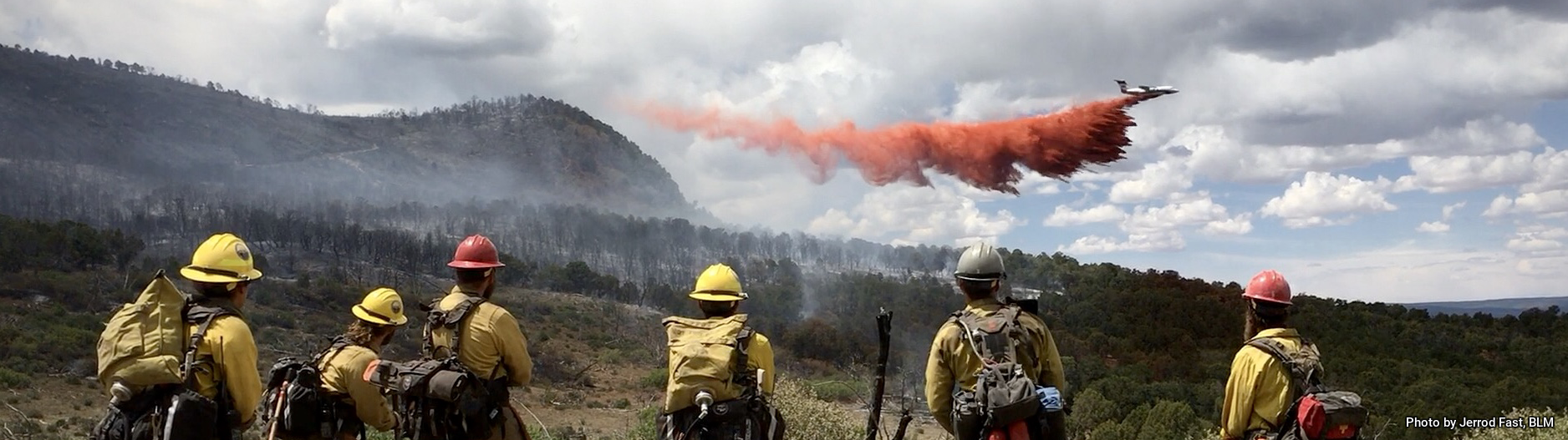 Wildland firefighters watch an airtanker drop retardant on the Horse Park Fire in Colorado in 2018. | Photo by Jerrod Fast, BLM
